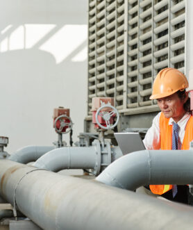 Vietnamese worker reading instruction before repairing plant equipment
